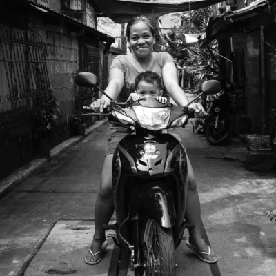 This mother is taking her child to school using her motorcycle