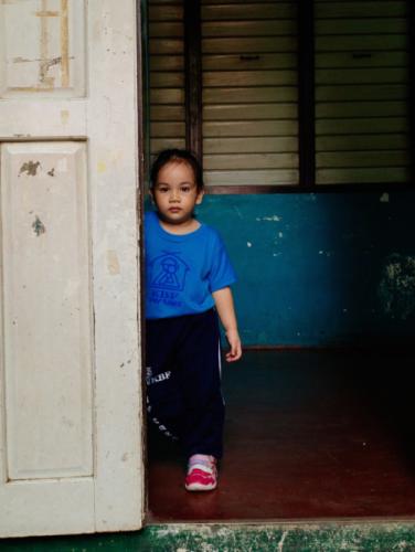 A day care student waiting for her mother to take her home after class